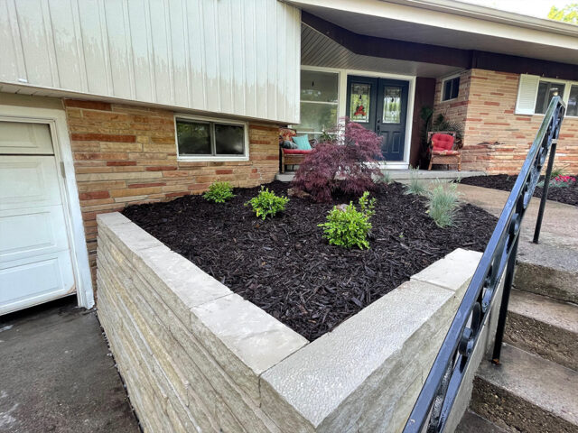 large retaining wall with garden in front of house