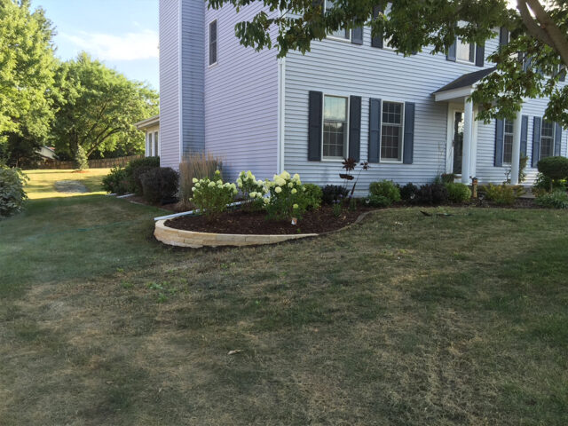 light color stone border garden in front of home