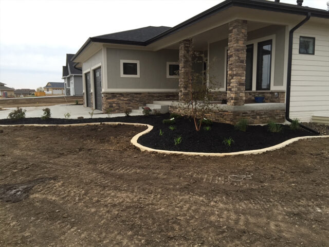 light colored brick border around landscape garden area
