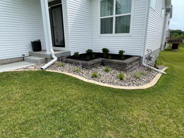 garden landscape area by home with raised brick retaining wall area