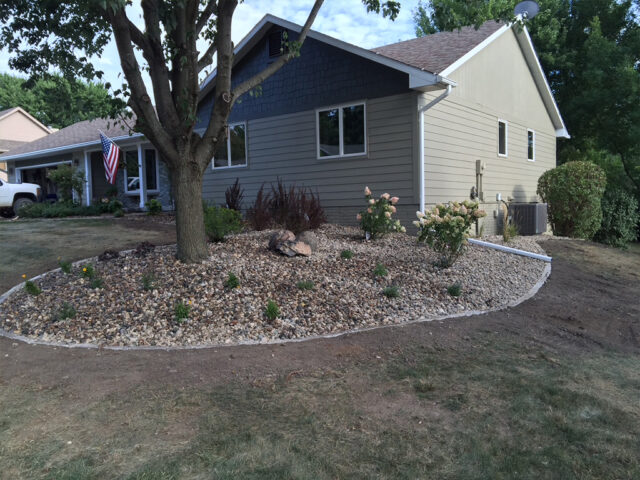 garden area with brick border and river rock