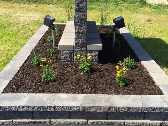 raised garden with brick and stone border