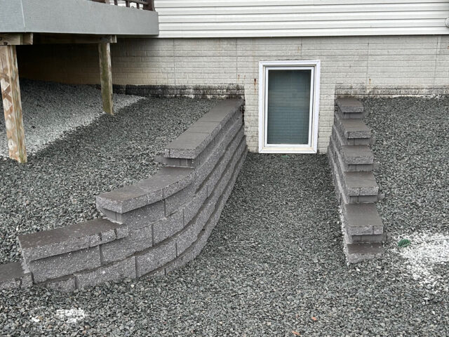 brick retaining wall leading to lower level window