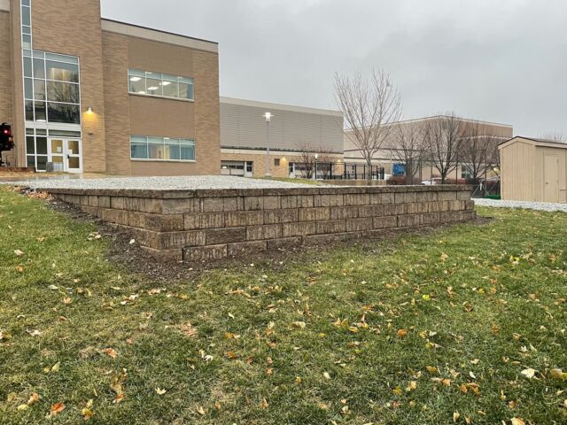 large brick retaining wall outside school
