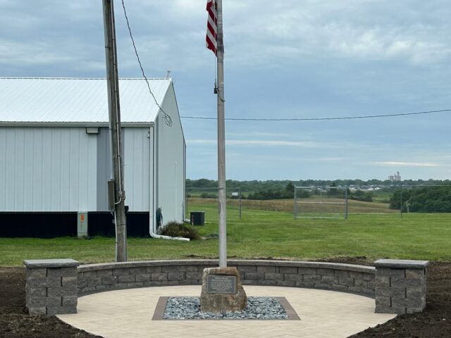 brick tile pathway to semicircle brick landscape flagpole area