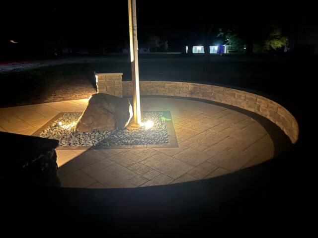 large tile circle with stones and flagpole