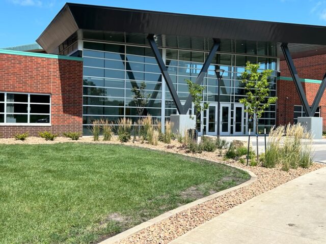 commercial building with stone garden area and brick border